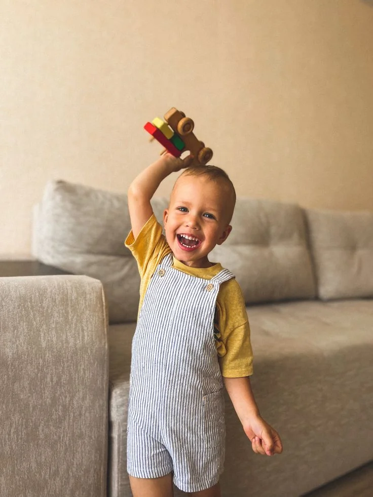 Child holding a toy car